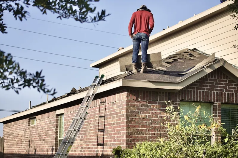 Professional roofer working on a residential roof in Boca Del Mar
